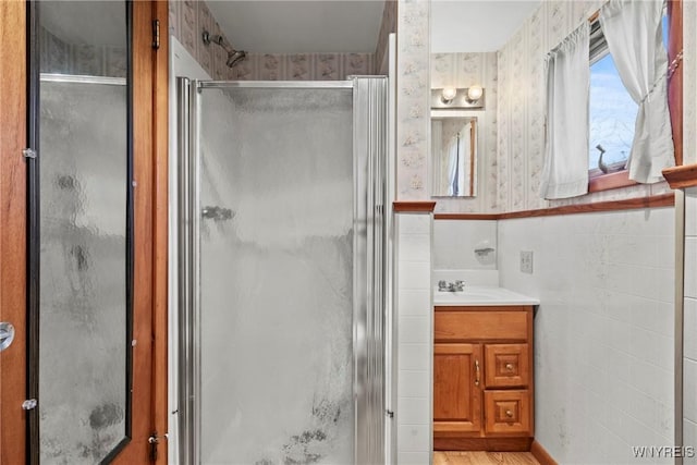 449 Madison Ave, Evans, NY 14006 - bathroom featuring a stall shower, vanity, and tile walls