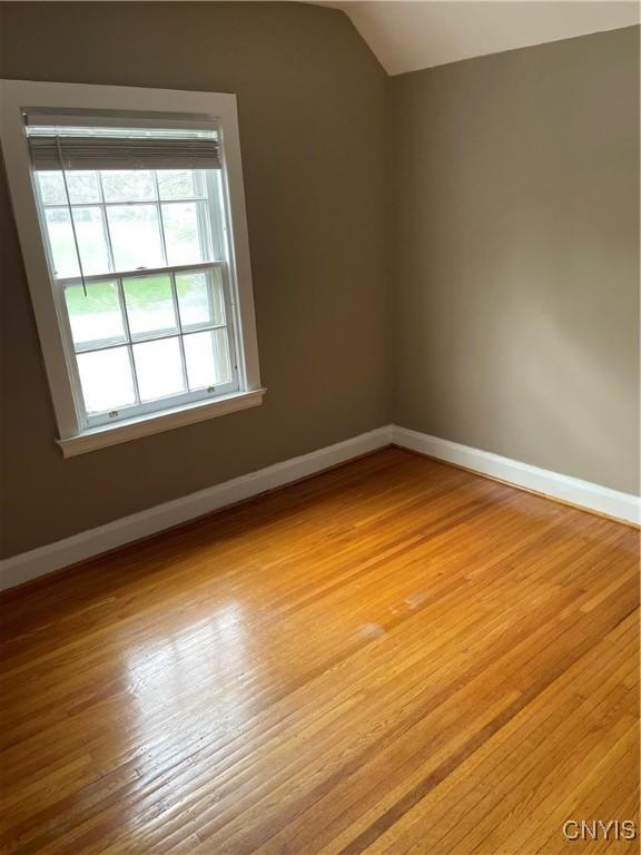 10 Sage Ct, Utica, NY 13502 - empty room with baseboards, lofted ceiling, and light wood-style floors