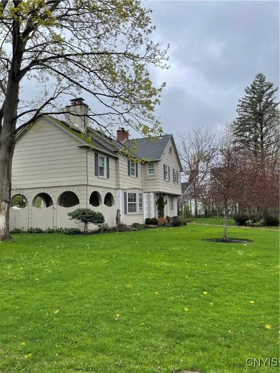 10 Sage Ct, Utica, NY 13502 - view of front of house with a front lawn and a chimney
