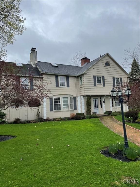 10 Sage Ct, Utica, NY 13502 - view of front of house featuring a chimney and a front lawn