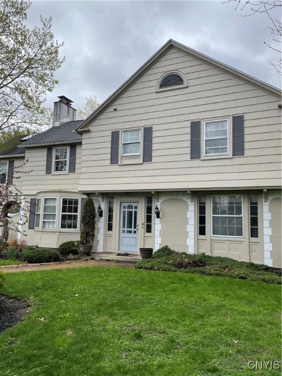 10 Sage Ct, Utica, NY 13502 - view of front of property with a front yard and a chimney