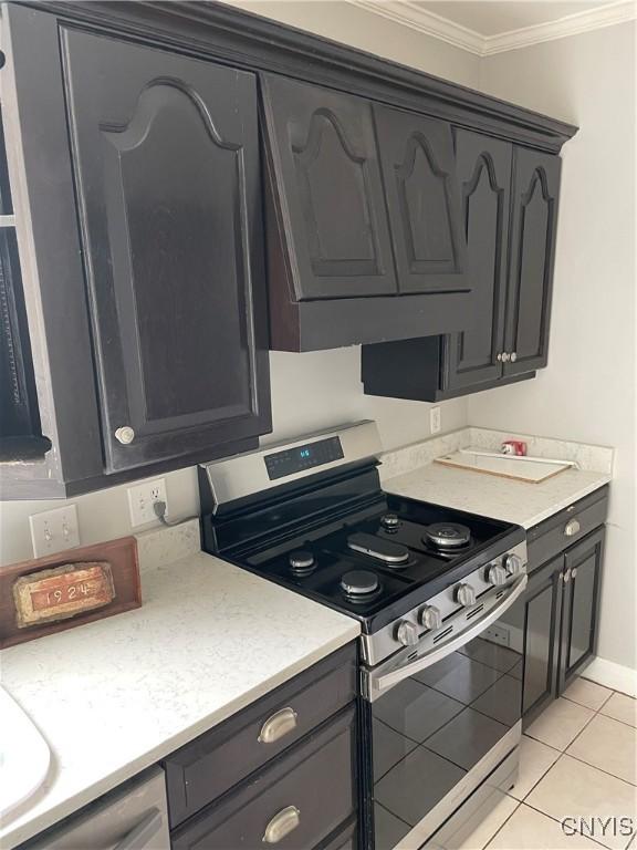 10 Sage Ct, Utica, NY 13502 - kitchen with stainless steel range oven, ornamental molding, light tile patterned floors, light countertops, and baseboards