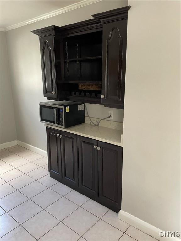 10 Sage Ct, Utica, NY 13502 - bar area featuring stainless steel microwave, baseboards, light tile patterned floors, and ornamental molding