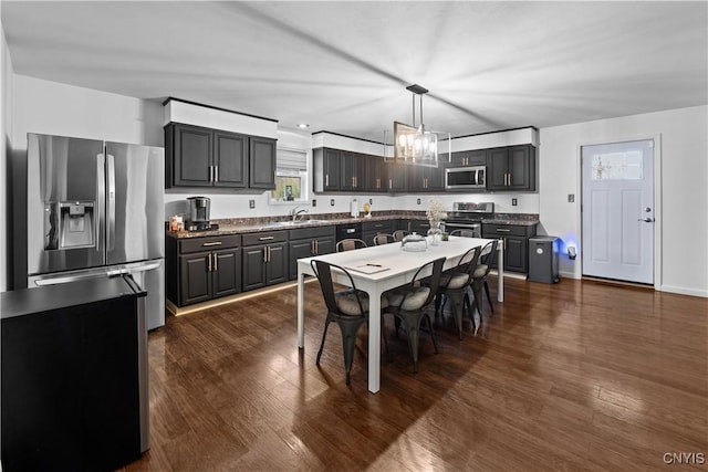 7678 Totman Rd, Cicero, NY 13212 - kitchen with appliances with stainless steel finishes, dark wood-style flooring, decorative light fixtures, and a chandelier