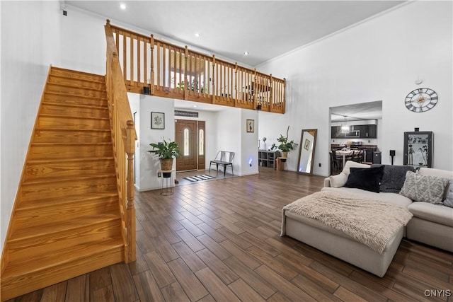 7678 Totman Rd, Cicero, NY 13212 - living area featuring a towering ceiling, stairway, wood finished floors, and baseboards