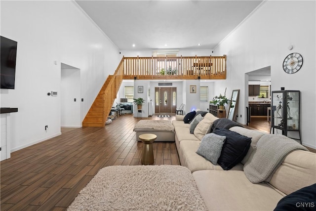 7678 Totman Rd, Cicero, NY 13212 - living area with crown molding, stairs, wood finished floors, a towering ceiling, and baseboards
