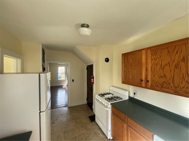 68 Maple Ave, Stamford, NY 13788 - kitchen with white appliances, brown cabinetry, backsplash, dark countertops, and baseboards