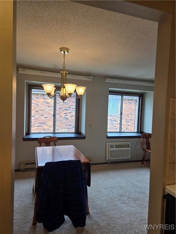 dining room featuring a textured ceiling, a chandelier, a wall unit AC, a baseboard radiator, and carpet flooring