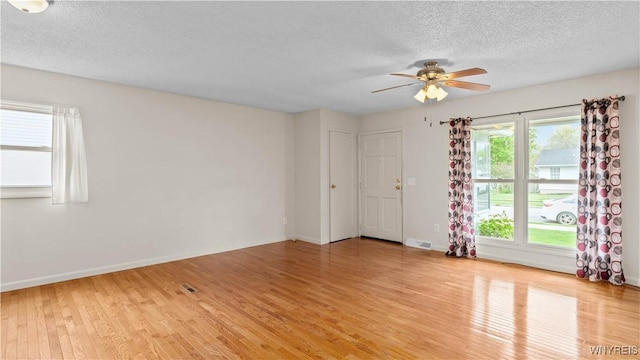 1350 Caravelle Dr, Niagara Falls, NY 14304 - empty room with light wood-style flooring, a textured ceiling, ceiling fan, and baseboards