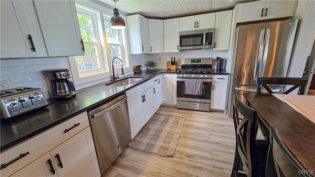 5416 W Lake Rd, Fleming, NY 13021 - kitchen featuring stainless steel appliances, a sink, white cabinetry, light wood-type flooring, and wooden ceiling
