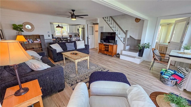 5416 W Lake Rd, Fleming, NY 13021 - living room featuring stairway, a ceiling fan, and light wood-style flooring