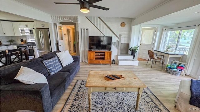 5416 W Lake Rd, Fleming, NY 13021 - living area with light wood-type flooring, stairway, and a ceiling fan