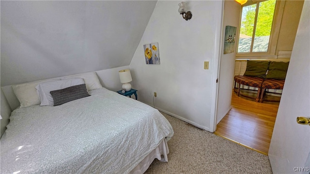 5416 W Lake Rd, Fleming, NY 13021 - carpeted bedroom with baseboards and lofted ceiling