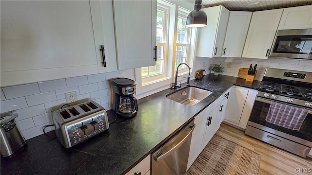 5416 W Lake Rd, Fleming, NY 13021 - kitchen with stainless steel appliances, a sink, white cabinets, and light wood-style flooring