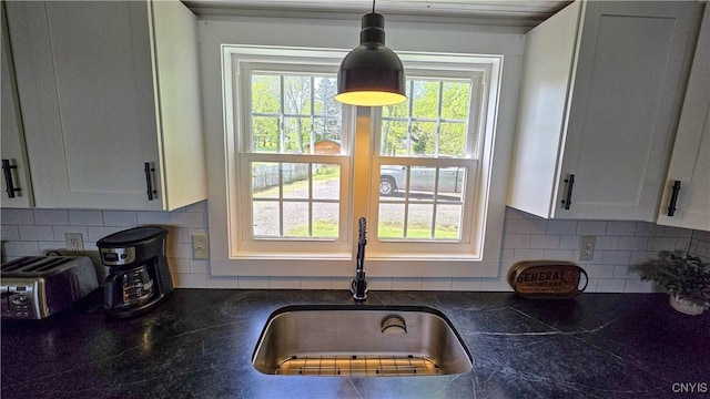 5416 W Lake Rd, Fleming, NY 13021 - kitchen with a sink, dark countertops, white cabinetry, decorative light fixtures, and backsplash