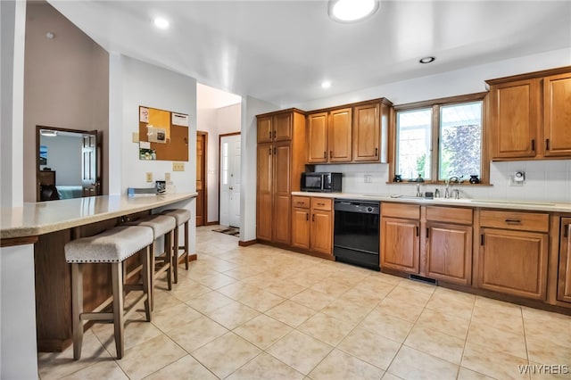 761 Pletcher Rd, Lewiston, NY 14092 - kitchen with black appliances, a sink, brown cabinets, tasteful backsplash, and light countertops