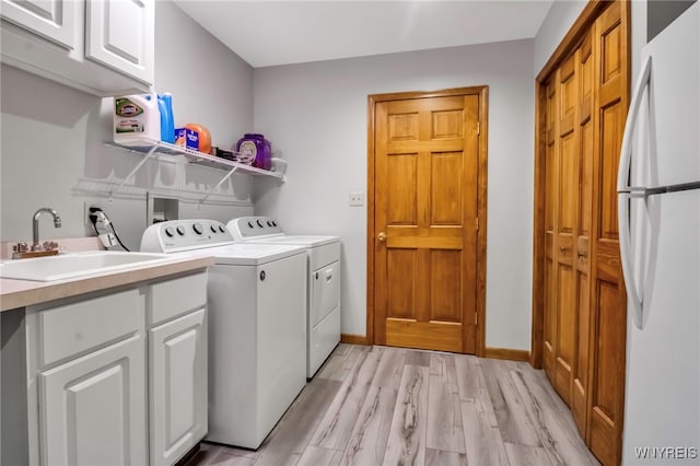 761 Pletcher Rd, Lewiston, NY 14092 - laundry room featuring light wood finished floors, washer and dryer, and cabinet space