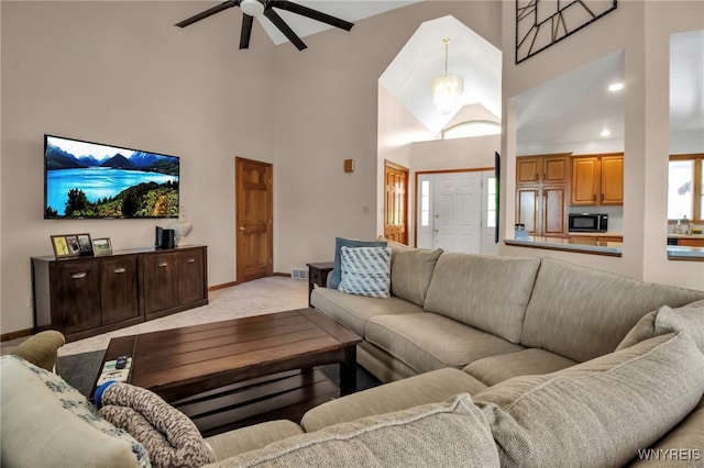 761 Pletcher Rd, Lewiston, NY 14092 - living area with high vaulted ceiling, light colored carpet, a ceiling fan, and baseboards