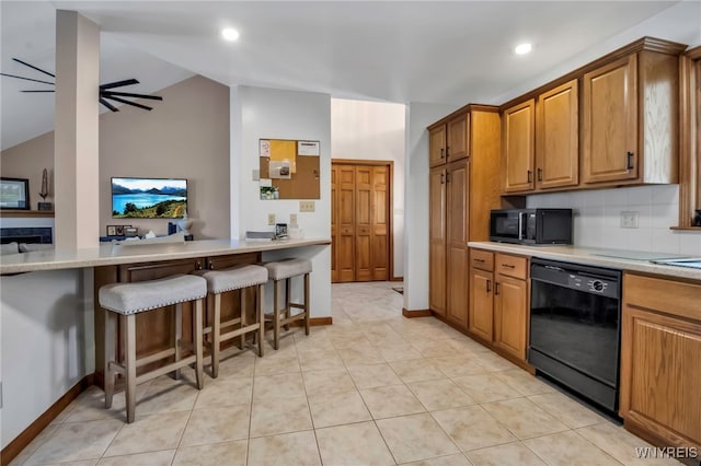 761 Pletcher Rd, Lewiston, NY 14092 - kitchen featuring black appliances, a kitchen breakfast bar, brown cabinets, vaulted ceiling, and light countertops