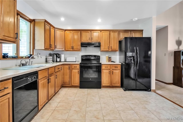 761 Pletcher Rd, Lewiston, NY 14092 - kitchen featuring black appliances, under cabinet range hood, light countertops, brown cabinetry, and a sink