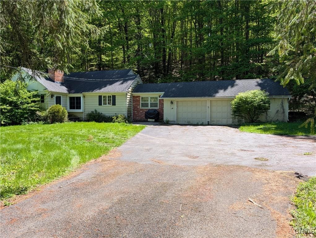 4719 Troop K Rd, Manlius, NY 13104 - ranch-style house featuring asphalt driveway, an attached garage, and a front lawn