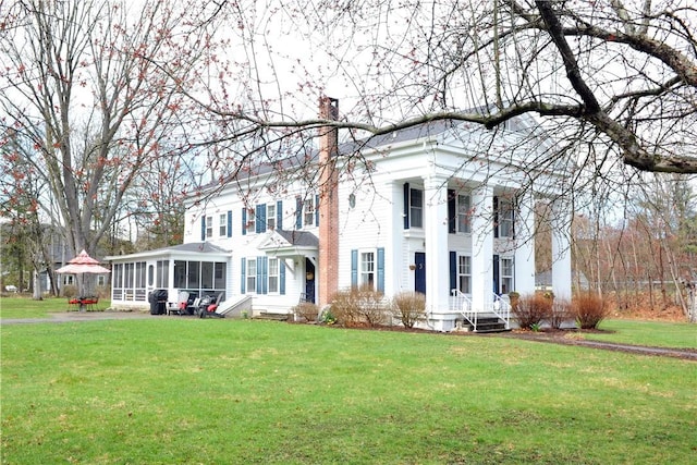 77 Hendy Creek Rd, Big Flats, NY 14905 - greek revival inspired property featuring a sunroom, a chimney, and a front yard