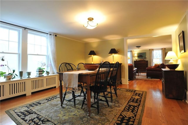 77 Hendy Creek Rd, Big Flats, NY 14905 - dining space with wood finished floors, radiator heating unit, and crown molding