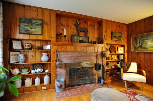 77 Hendy Creek Rd, Big Flats, NY 14905 - living area with a brick fireplace, wooden walls, and wood-type flooring