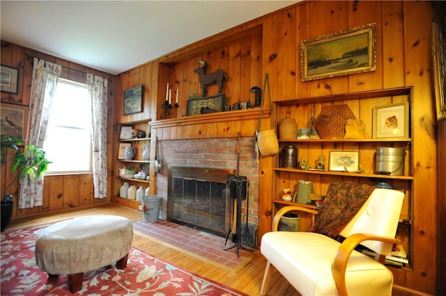 77 Hendy Creek Rd, Big Flats, NY 14905 - living area with wooden walls, wood finished floors, and a fireplace