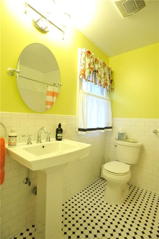 77 Hendy Creek Rd, Big Flats, NY 14905 - bathroom with tile walls, tile patterned floors, wainscoting, and toilet