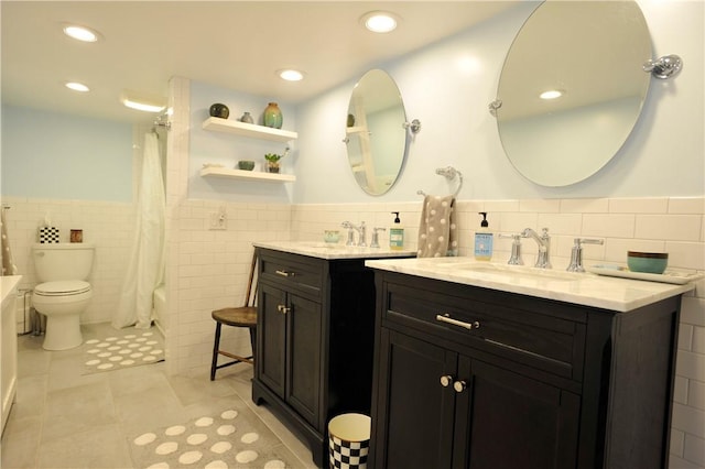 77 Hendy Creek Rd, Big Flats, NY 14905 - bathroom featuring tile walls, tile patterned floors, a wainscoted wall, toilet, and two vanities