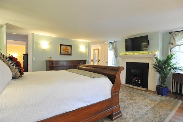 77 Hendy Creek Rd, Big Flats, NY 14905 - bedroom with wood finished floors and a fireplace