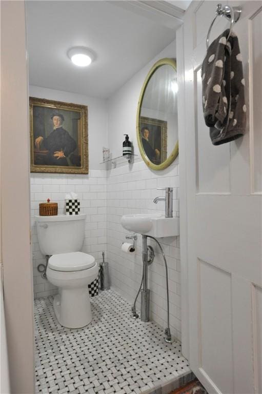77 Hendy Creek Rd, Big Flats, NY 14905 - half bathroom featuring toilet, tile walls, tile patterned floors, a sink, and wainscoting