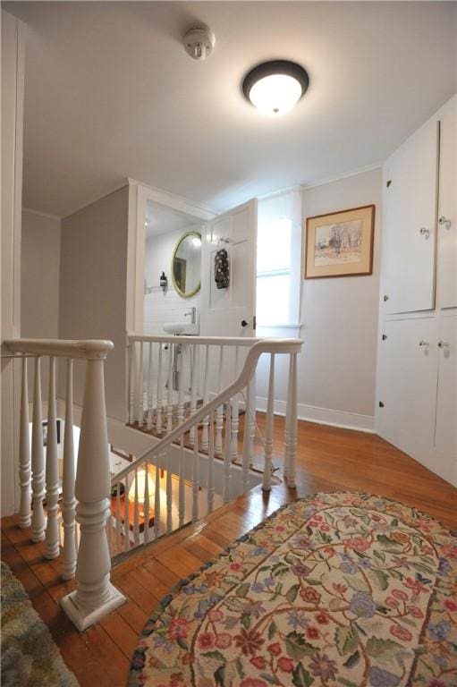 77 Hendy Creek Rd, Big Flats, NY 14905 - corridor with an upstairs landing, hardwood / wood-style flooring, and baseboards