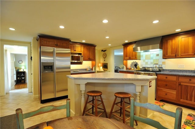77 Hendy Creek Rd, Big Flats, NY 14905 - kitchen featuring stainless steel appliances, wall chimney range hood, recessed lighting, a center island, and light tile patterned flooring