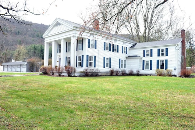77 Hendy Creek Rd, Big Flats, NY 14905 - neoclassical home with a chimney and a front yard