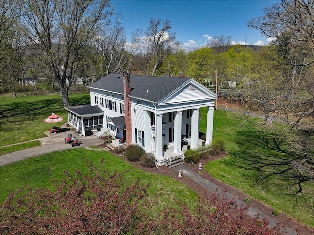 77 Hendy Creek Rd, Big Flats, NY 14905 - view of front of property featuring a chimney, a front yard, a shingled roof, and covered porch