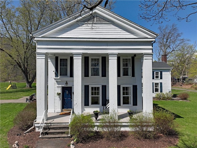 77 Hendy Creek Rd, Big Flats, NY 14905 - neoclassical home featuring a porch, a chimney, and a front yard