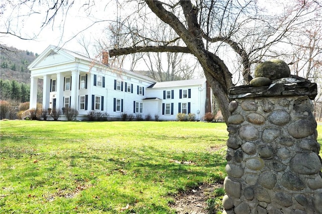 77 Hendy Creek Rd, Big Flats, NY 14905 - greek revival inspired property featuring a chimney and a front yard