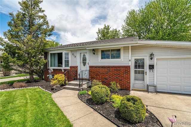 view of front of home featuring brick siding, a front yard, an attached garage, and concrete driveway