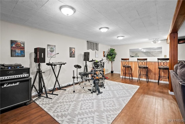 exercise room featuring wood finished floors