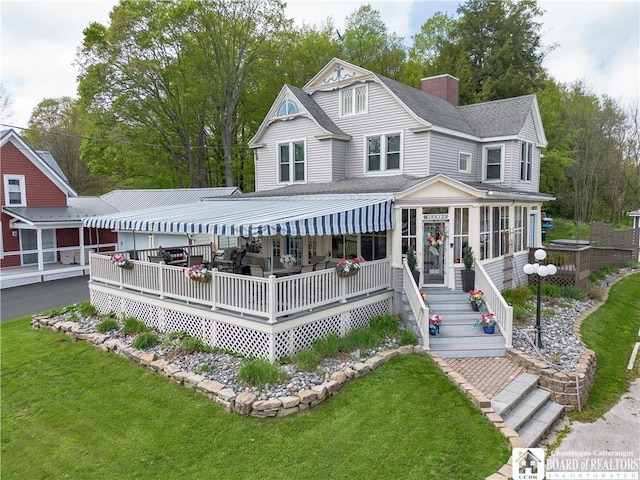 10412 Main St, Mina, NY 14736 - view of front of property with a front lawn, roof with shingles, a chimney, and a sunroom