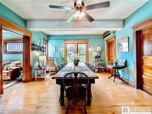 10412 Main St, Mina, NY 14736 - dining area with light wood-style floors, a ceiling fan, a wall mounted AC, a textured ceiling, and baseboards
