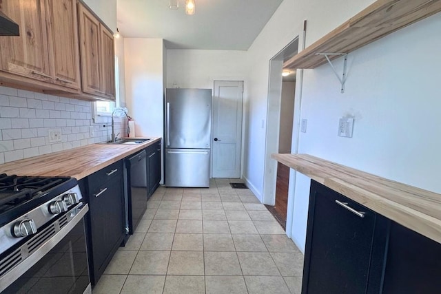 5 Bronk St, Oneonta-City, NY 13820 - kitchen with stainless steel appliances, a sink, butcher block countertops, light tile patterned floors, and decorative backsplash