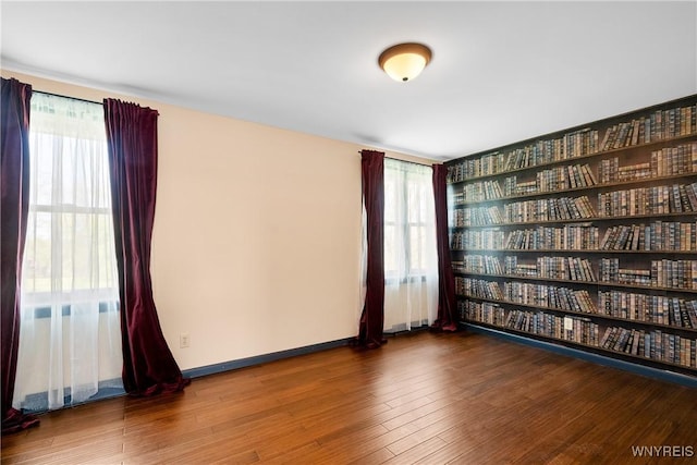 empty room featuring wood finished floors and baseboards