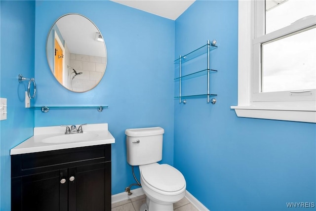 bathroom with toilet, baseboards, vanity, and tile patterned flooring
