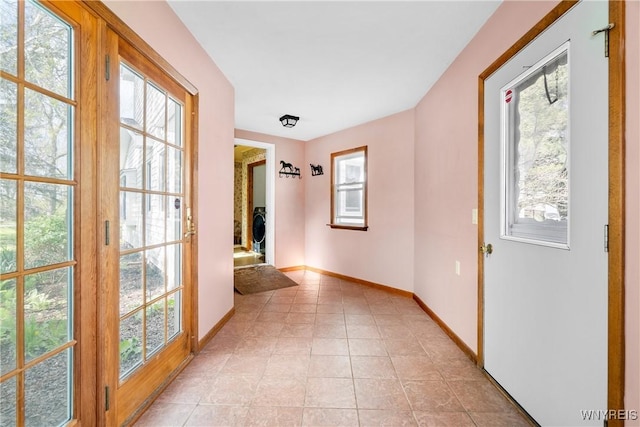hallway featuring baseboards and healthy amount of natural light