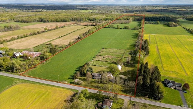 aerial view of sparsely populated area with farmland, property parcel outlined, and agricultural land