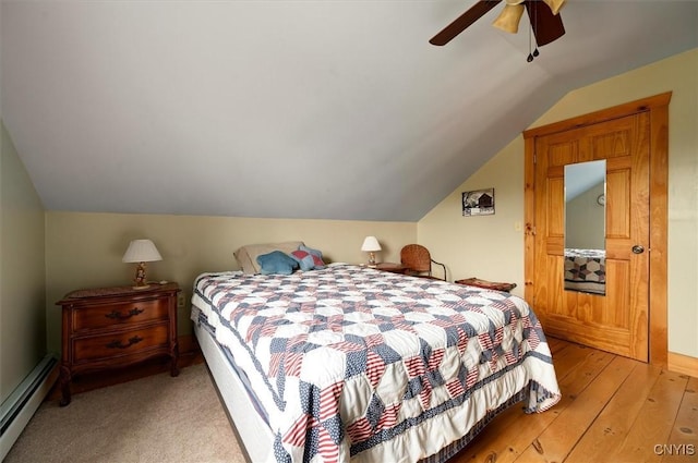 463 Hughes Rd, Russia, NY 13438 - bedroom featuring a baseboard heating unit, vaulted ceiling, a ceiling fan, and light wood-style flooring