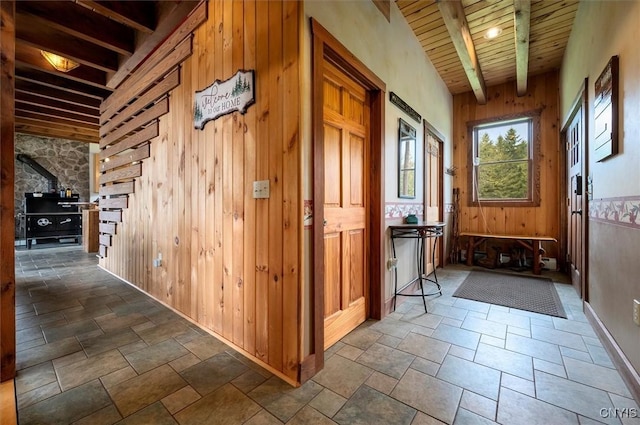 463 Hughes Rd, Russia, NY 13438 - corridor with stone tile flooring, wooden walls, wooden ceiling, and baseboards